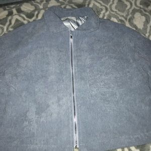 a girls cord blue jacket with a front pocket.